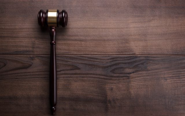 Judge's gavel laid on a dark wood table