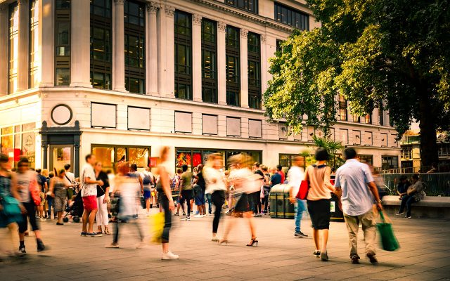 Retail premises in a city surrounded by people shopping